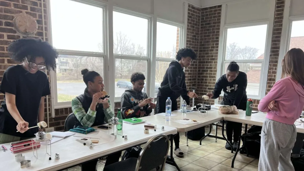 Homeschooled high school students at eXtend Homeschool Tutorial participate in a chemistry class